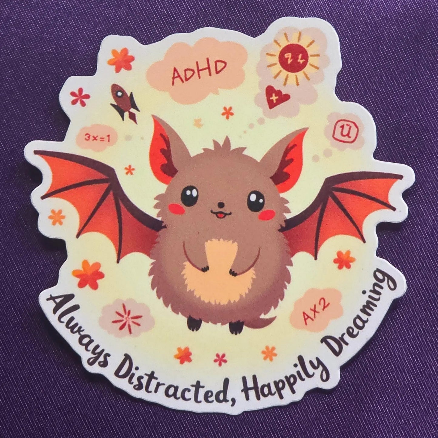 Sticker with a cute ADHD bat illustration and text on a purple background