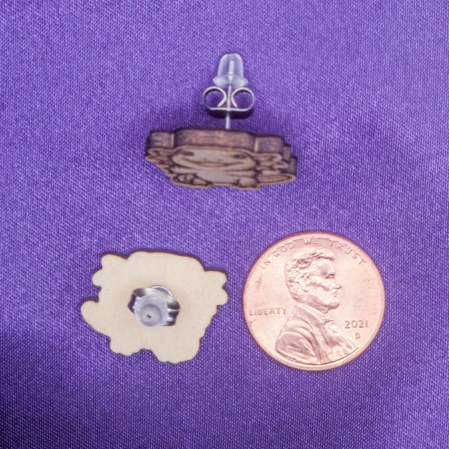 set of laser engraved earrings wooden featuring happy axotyls next to a penny for scale