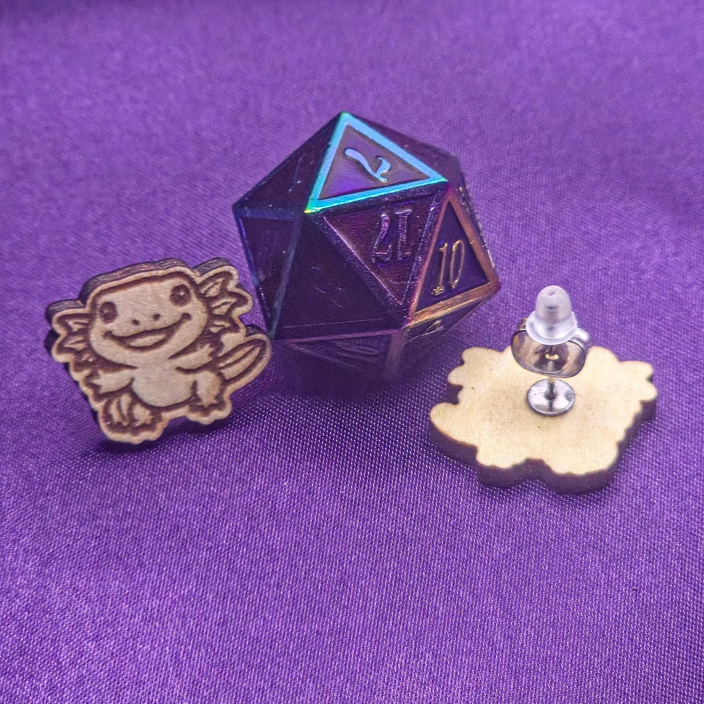 set of laser engraved earrings wooden featuring happyn axotyls next to a metal purple d20
